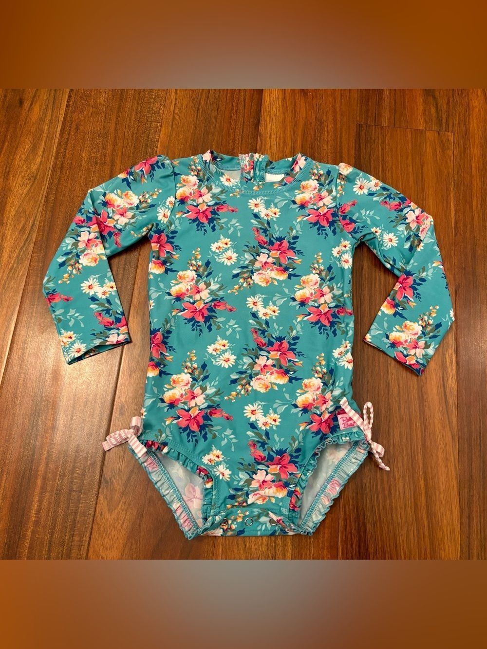 RuffleButts blue floral long sleeve rashguard one piece bathing suit